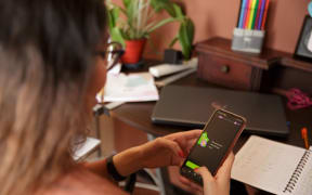 A woman uses the Duolingo app.