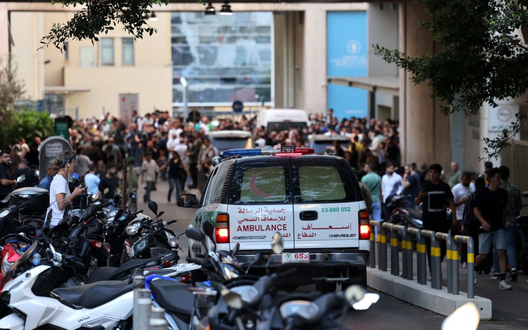 An ambulance rushes wounded people to the American University of Beirut Medical Center, on 17 September, 2024, after explosions hit locations in several Hezbollah strongholds around Lebanon amid ongoing cross-border tensions between Israel and Hezbollah fighters.