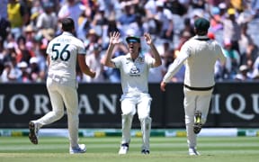 Mitchell Marsh, centre, celebrates with Australian team-mates after the dismissal of Virat Kohli of India on day five of the fourth cricket test at the Melbourne Cricket Ground.