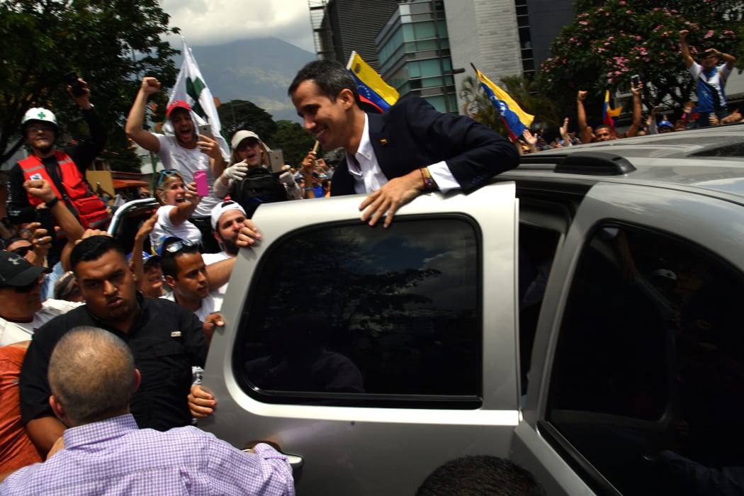 Venezuelan opposition leader and self-proclaimed acting president Juan Guaido greets supporters upon his arrival in Caracas on March 4, 2019.