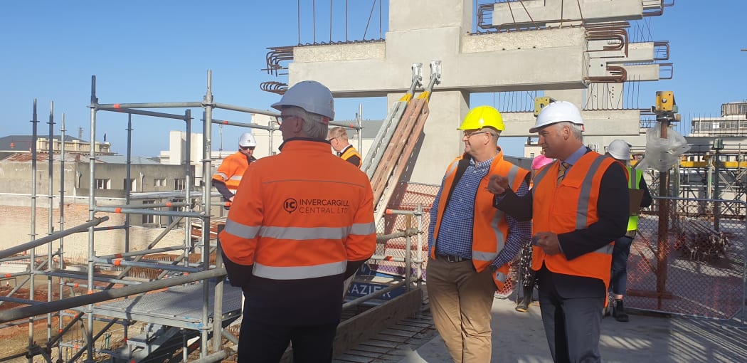 Regional Development Minister Stuart Nash reviewing progress at Invercargill's inner city development with officials on 18 March, 2021.