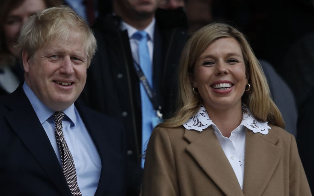 (FILES) In this file photo taken on March 07, 2020 Britain's Prime Minister Boris Johnson (L) with his partner Carrie Symonds attend the Six Nations international rugby union match between England and Wales at the Twickenham, west London.