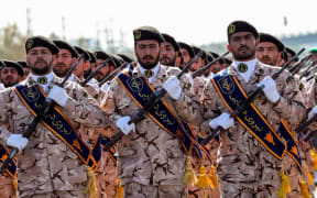 (FILES) In this file photo taken on September 22, 2018 members of Iran's Revolutionary Guards Corps (IRGC) march during the annual military parade