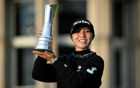 New Zealand's Lydia Ko poses with the trophy after winning the 2024 Women's British Open Golf Championship.