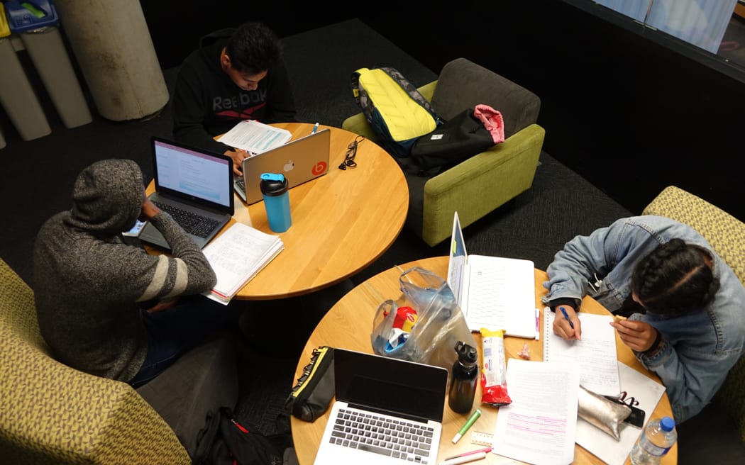 Heads down, snacks out, up and alert. Students (left to right) Wayne Kalotiti, Veli Pavihi and Nara Su are too busy to do anything but study at the Victoria University’s Campus Hub.