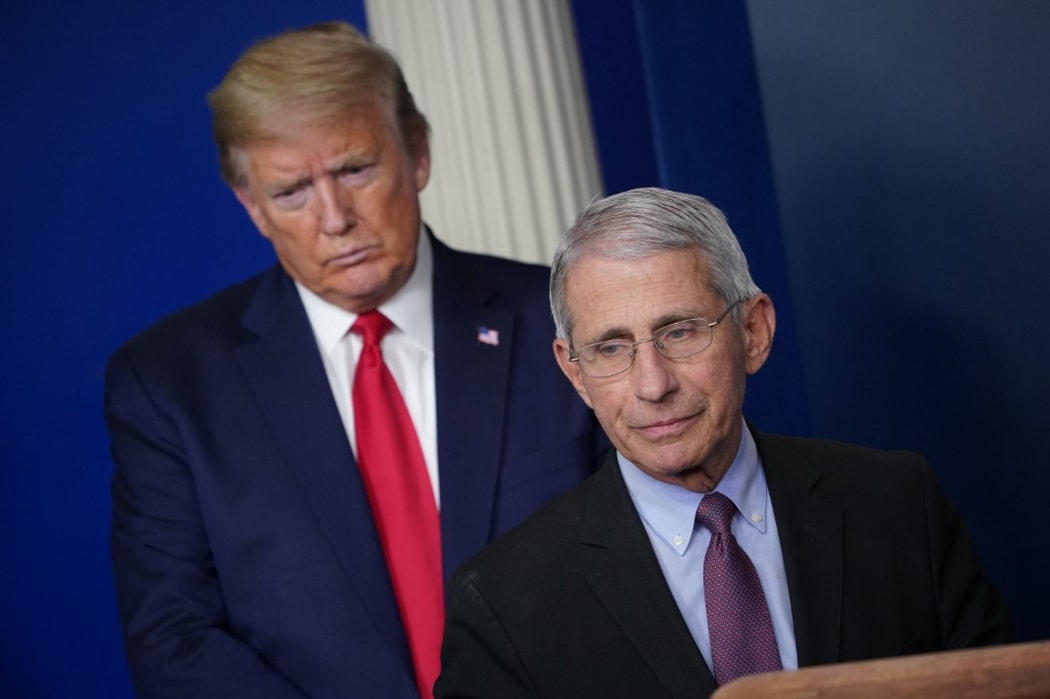Director of the National Institute of Allergy and Infectious Diseases Anthony Fauci, flanked by US President Donald Trump, speaks during the daily briefing on the novel coronavirus, which causes COVID-19, in the Brady Briefing Room of the White House on April 22, 2020, in Washington, DC.