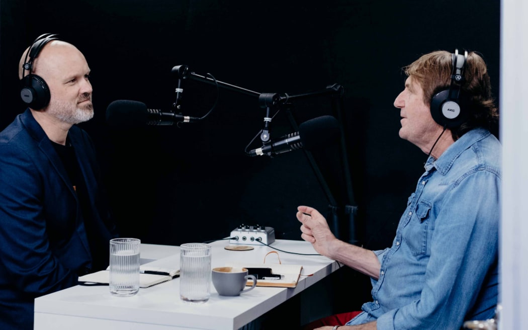 Reverend Frank Ritchie interviews journalist Cameron Bennett in a small broadcasting studio
