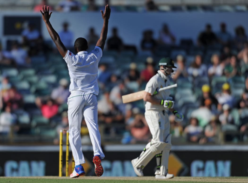 South African cricketer Kagiso Rabada celebrates the wicket of Steve Smith during their first Test against Australia
