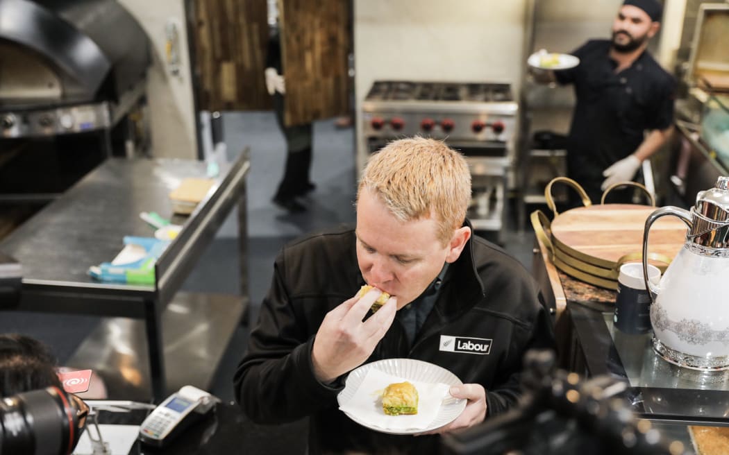 No, it's not a sausage roll! Chris Hipkins tucks into a baklava at a Porirua kebab shop.