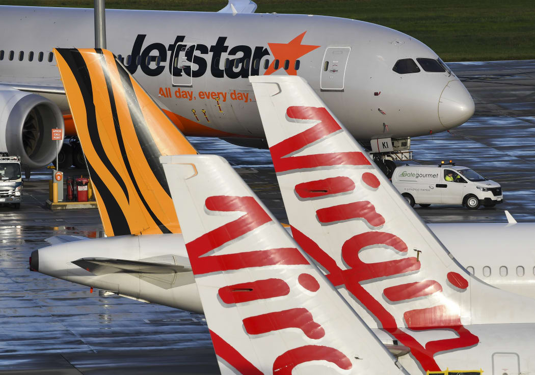 Jetstar, Tiger and Virgin planes sit idle on the tarmac at Melbourne's Tullamarine Airport on 12 April 2020.