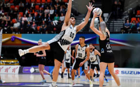 NZ Men's Junior Levi on defence against Silver Ferns Jane Watson.