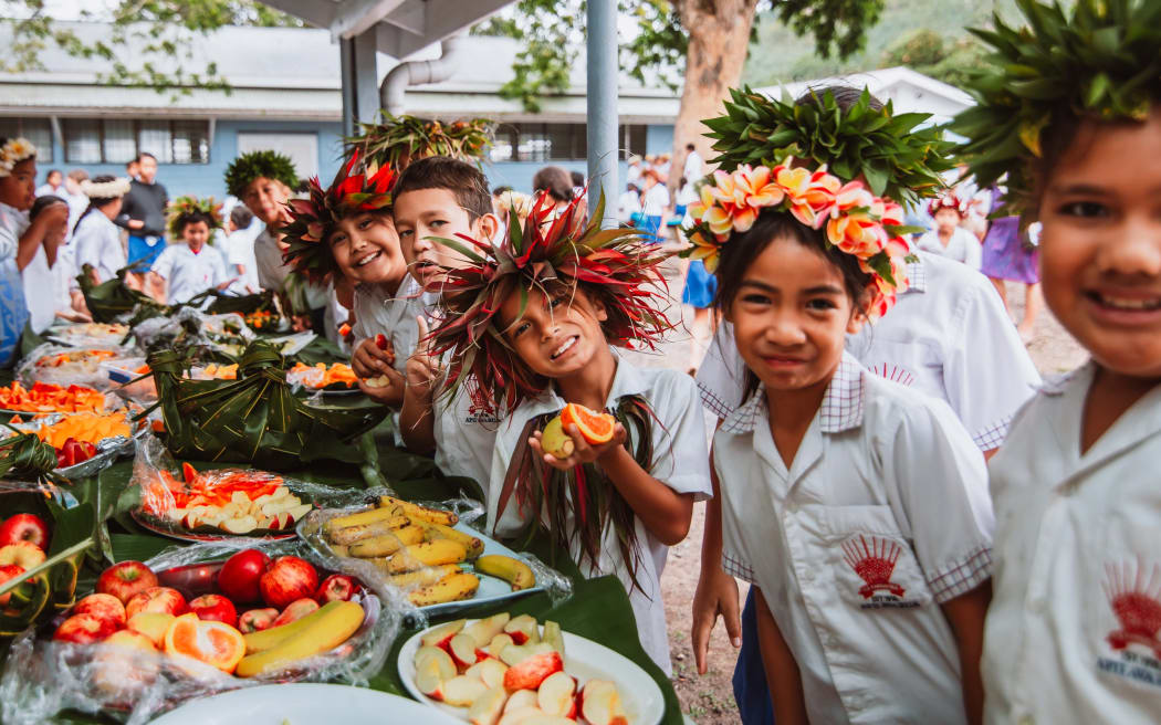 Children in Cook Islands welcome the United Nations Committee on the Rights of the Child chair, Ann Marie Skelton to their home.