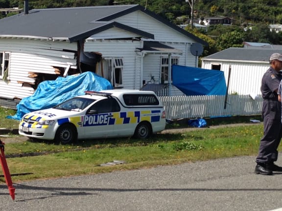 The crash scene on High St Greymouth. The crashed vehicle is under the blue tarpaulin.
