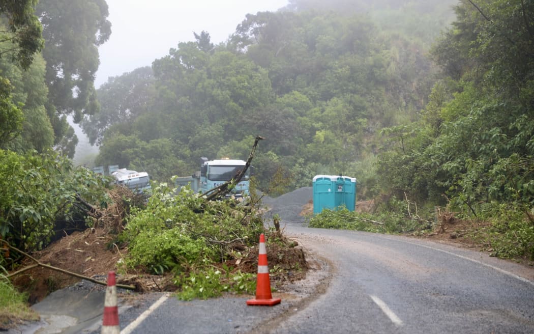 Russell Road heading to Oakura. Several fresh slips with road workers clearing the larger ones. Very humid with a lot of fog along the road. Rain is light.