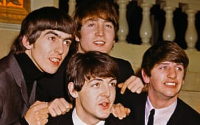 The Beatles' George Harrison, John Lennon (top), Paul McCartney (bottom), and Ringo Starr in 1964.