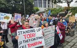 Teachers strike outside Parliament on Wednesday.
