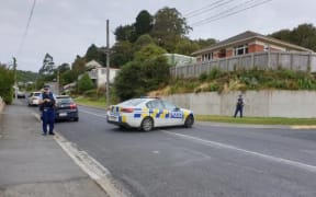 Police at the scene on Somerville St in Dunedin earlier today. Photo / Tim Brown