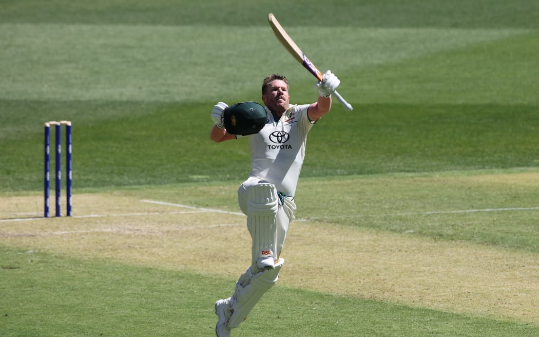 Australia’s David Warner celebrates his century during the first day of the first Test cricket match between Australia and Pakistan in Perth, 2023.