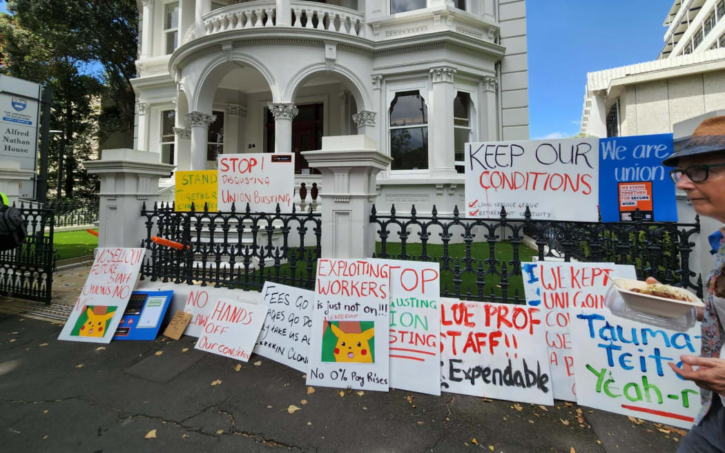 More than 100 University of Auckland staff and supporters rally for workers' rights on Princes Street on 1 March, 2023.