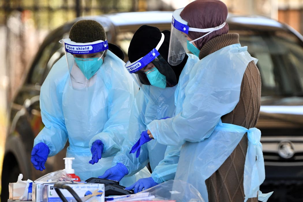 Health workers taking swab samples from residents at a Covid-19 drive-through testing clinic in Sydney on 28 July, 2021.