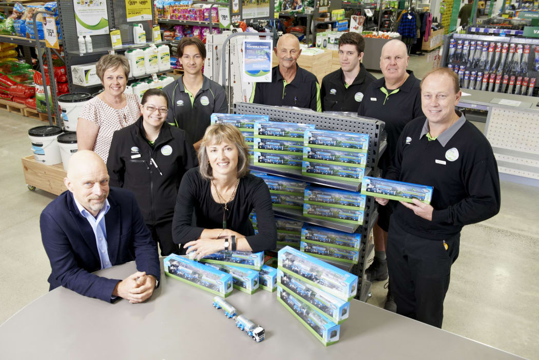 Matt Shirtcliffe (Executive Creative Director, Shirtcliffe & Co - bottom left), Shelley Creswell, Fonterra Farm Source (top left), Michelle Thompson (Chief Executive, RHĀNZ - bottom right) and staff with the mini tankers at the Fonterra Farm Source Store in Cambridge.
