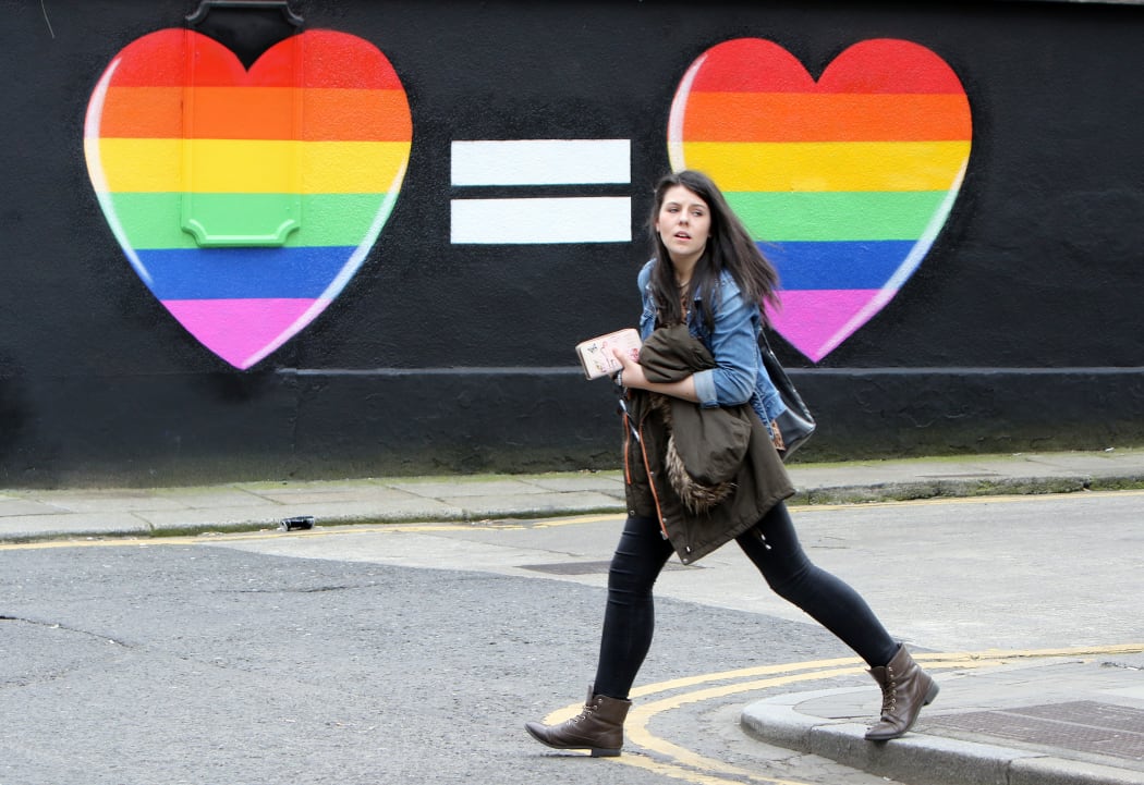A woman walks past a mural backing same-sex marriage in Ireland on 21 May.