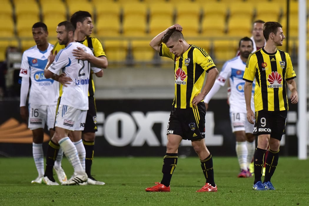 Disappointed Phoenix players congratulate the Victory on their win