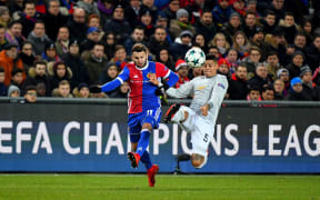 Renato Steffen of FC Basel challenges Marcus Rojo of Manchester United for the ball