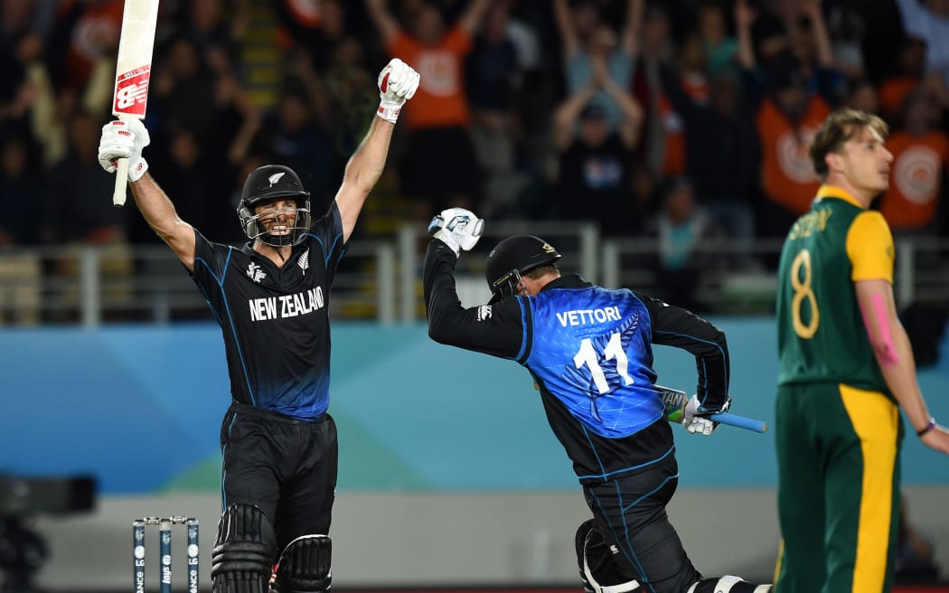 Grant Elliott celebrates hitting the winning runs to put New Zealand into their first Cricket World Cup final.