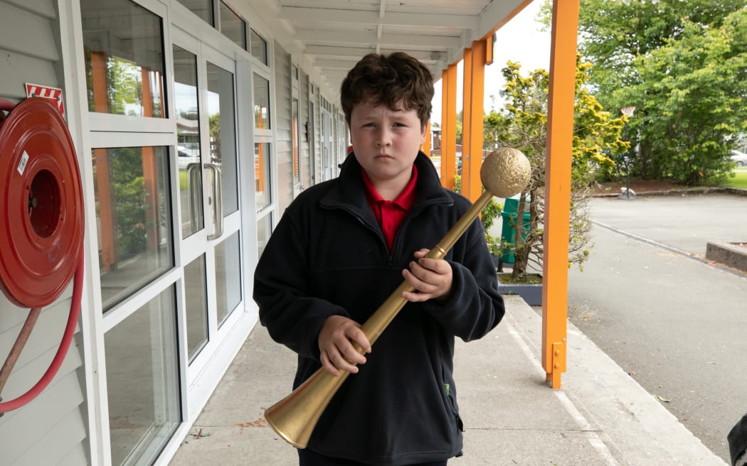 Westport South primary school student Jack Neighbours holds the mace for the mock parliament debate held 20 November 2022 during the visit by five MPs as part of a Parliament Outreach programme.