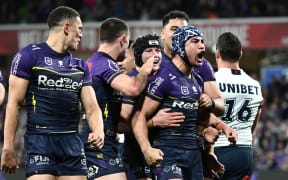 Jahrome Hughes of the Storm celebrates scoring a try with teammates during the NRL Preliminary Final match against the Sydney Roosters.