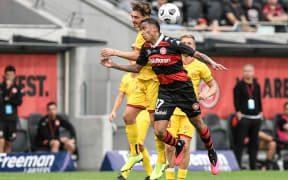 Josh Cavallo of Adelaide United and Keanu Baccus of Western Sydney Wanderers compete for the header.