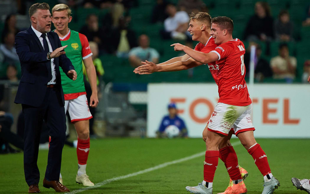 The Phoenix and Ufuk Talay coach of the Wellington Phoenix celebrate a goal by Ben Waine against Perth Glory at HBF Park on April 18 2021 in Perth, Australia.