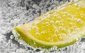 Abstract of lime and bubbles in a gin and tonic