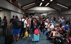 Passengers try to rest and sleep after canceled and delayed flights while others wait to board flights off the island as thousands of passengers were stranded at the Kahului Airport (OGG) in the aftermath of wildfires in western Maui in Kahului, Hawaii on August 9, 2023. The death toll from a wildfire that turned a historic Hawaiian town to ashes has risen to 36 people, officials said on August 9.