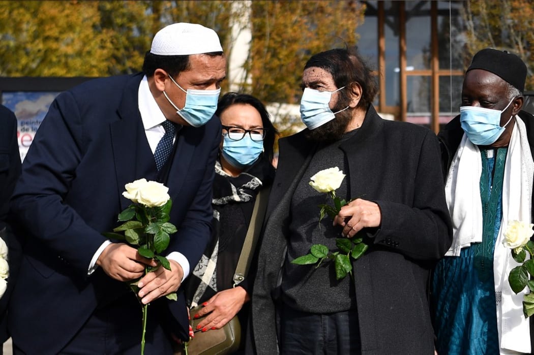 Imam of Drancy Hassen Chalghoumi (L) and French Jewish writer Marek Halter (2nd R) attend a gathering of imams outside the Bois d'Aulne secondary school