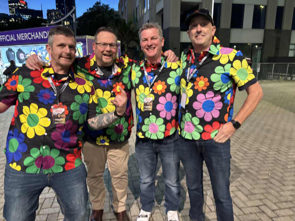 Four men in bright floral shirts.