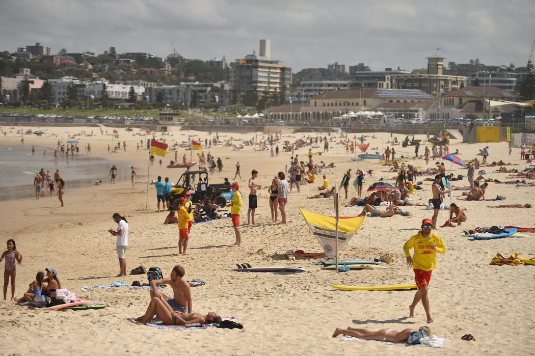 People sunbathing on Bondi Beach on 22 March, the day before it's closure to stop the spread of Covid-19.
