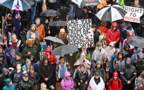 Members of the Freedom and Rights Coalition take part in a protest outside the police station in Christchurch, New Zealand