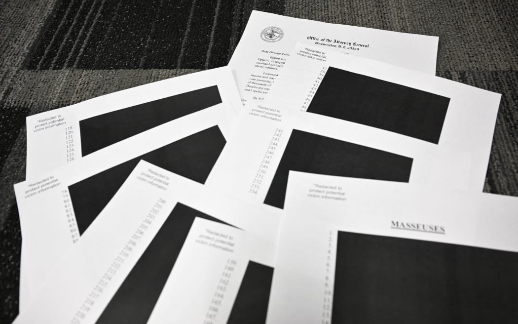 A photo illustration showing redacted documents, after the US Justice Department began releasing the long-awaited records from the investigation into the politically explosive case of convicted sex offender Jeffrey Epstein.