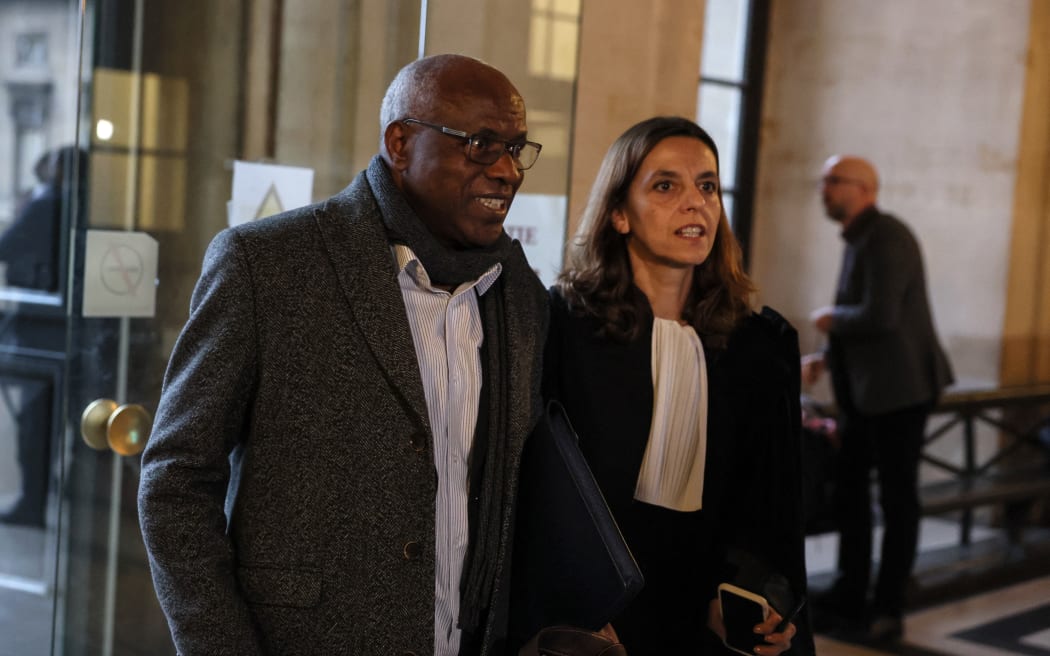Rwandan doctor Sosthene Munyemana (L) arrives with his lawyer Florence Bourg (R) at the Paris courthouse for his trial on charges of genocide and crimes against humanity during the 1994 massacres in Rwanda, on November 14, 2023.