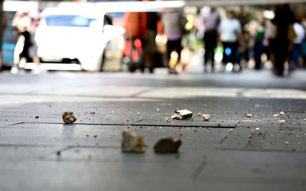Pieces of debris on the ground of Auckland's Queen St.