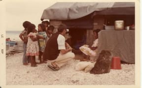 Joe Murphy, reporter, drew a crowd of children as he conducted an interview in Majuro in the late 1970s.
