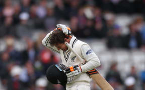 BJ Watling completes a run holding his head after being hit by a Mark Wood delivery during the first Investec Test Match between England and New Zealand at Lord's Cricket Ground, London.