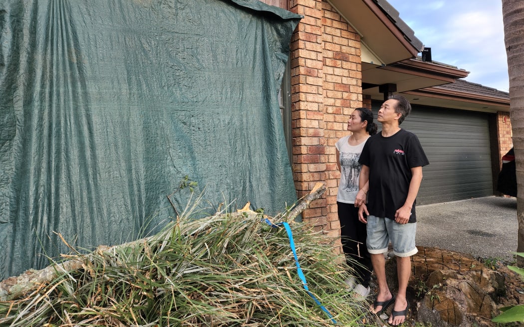 East Tamaki residents Ramil Casas and his wife Nema Rose saw significant damage to their rental property.  
Ramil Casas says he was only narrowly missed by the tree branches which smashed through his window just before 9pm on Sunday. He says he was working in the living room when the wind started howling, he went near the window hoping to check, and that was when the branches cut through the glass.  He says he feels lucky that they're now safe "It's like surreal, we can't believe that we survived the tornado". Ramil Cases says their roof was also damaged, and meanwhile tiles from a neighbour's roof had smashed into his flatmates' car.