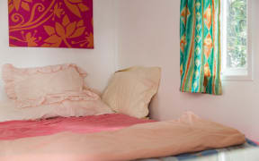 A bed inside one if Island Child Charitable Trust emergency houses.