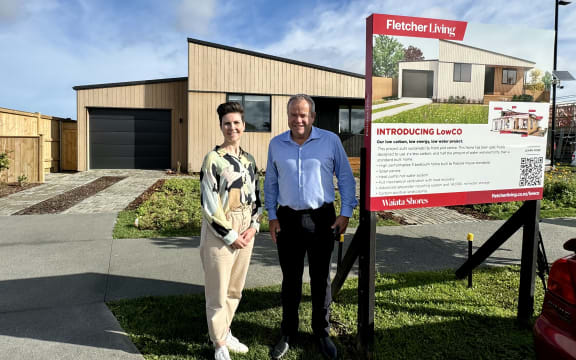 Nicola Tagiston and Steve Evans from Fletcher Living outside the South Auckland home that achieved the highest possible climate-friendly rating.