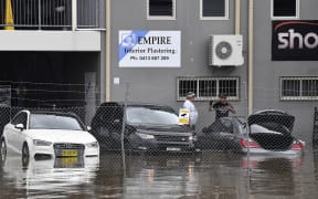 Residents in the southwestern Sydney suburb of Camden check cars stranded in floodwaters on 8 March 2022.