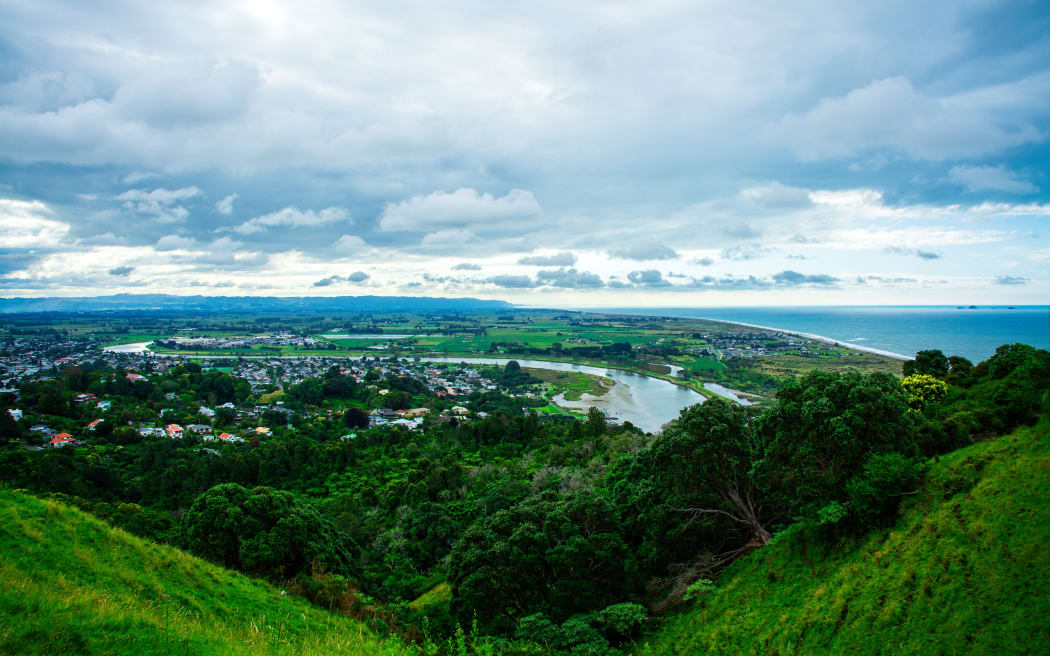 Panoramic aerial view over town of Whakatane. The heart of the Eastern Bay of Plenty, New Zealand, it's nested between Whakatane River and bush-clad cliffs. Breathtaking New Zealand Landscape. Kohi Point Lookout, Whakatane, New Zealand.