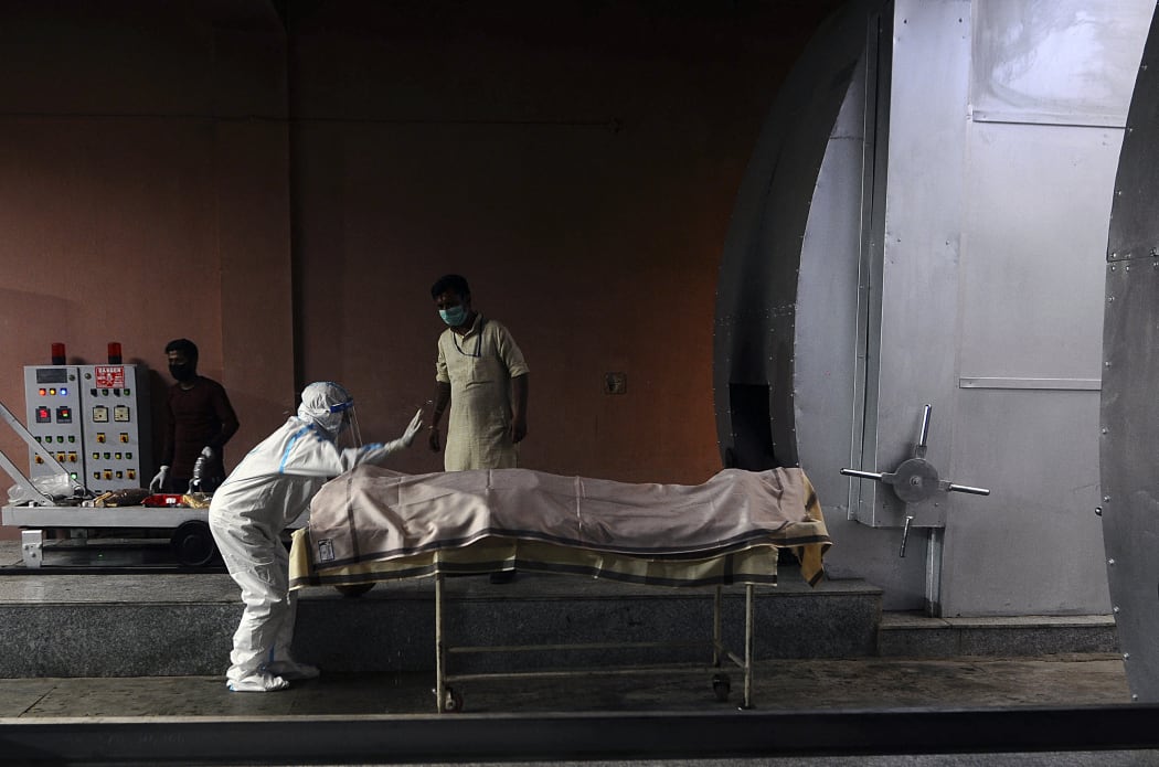 A relative of a Covid-19 victim prays before the cremation, at Nigambodh Ghat crematorium in New Delhi, India on April 07, 2021.